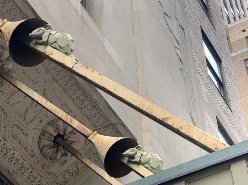 Rodent-proofing design at the Graybar Building in NYC – architectural cone baffles blocking cement rats, symbolizing historic pest prevention.