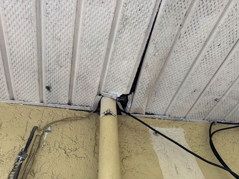 Open gap where an AC line enters a soffit