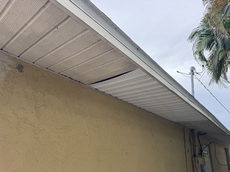 A sagging soffit panel leaving a gap under the roofline of a Southwest Florida home