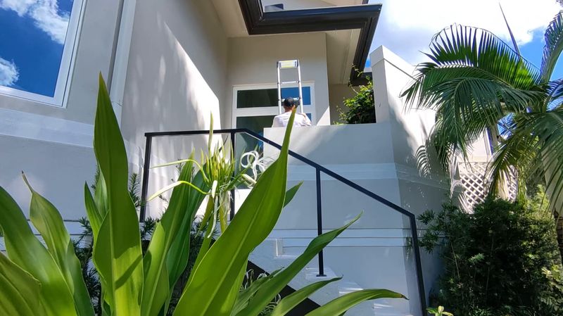 Paul Trapp of Seal Em Out with his ladder at a Southwest Florida home